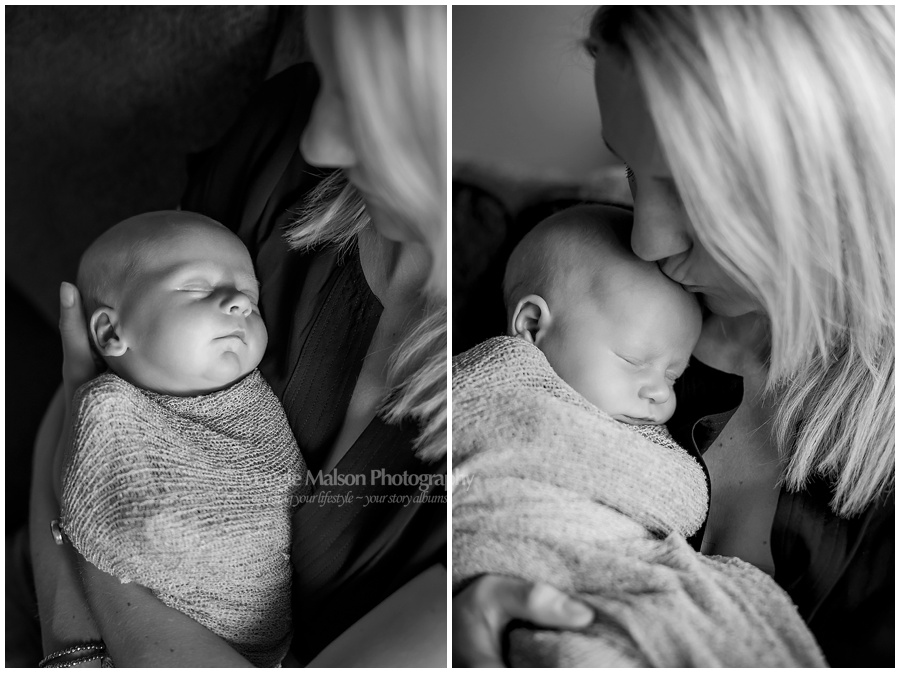 mother kissing newborn